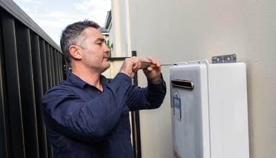 Joseph from The Brisbane Plumbers servicing a gas hot water system at a Brisbane home